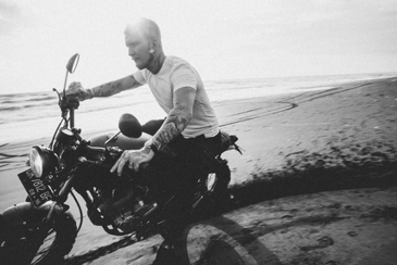 Motorcyclist riding on beach